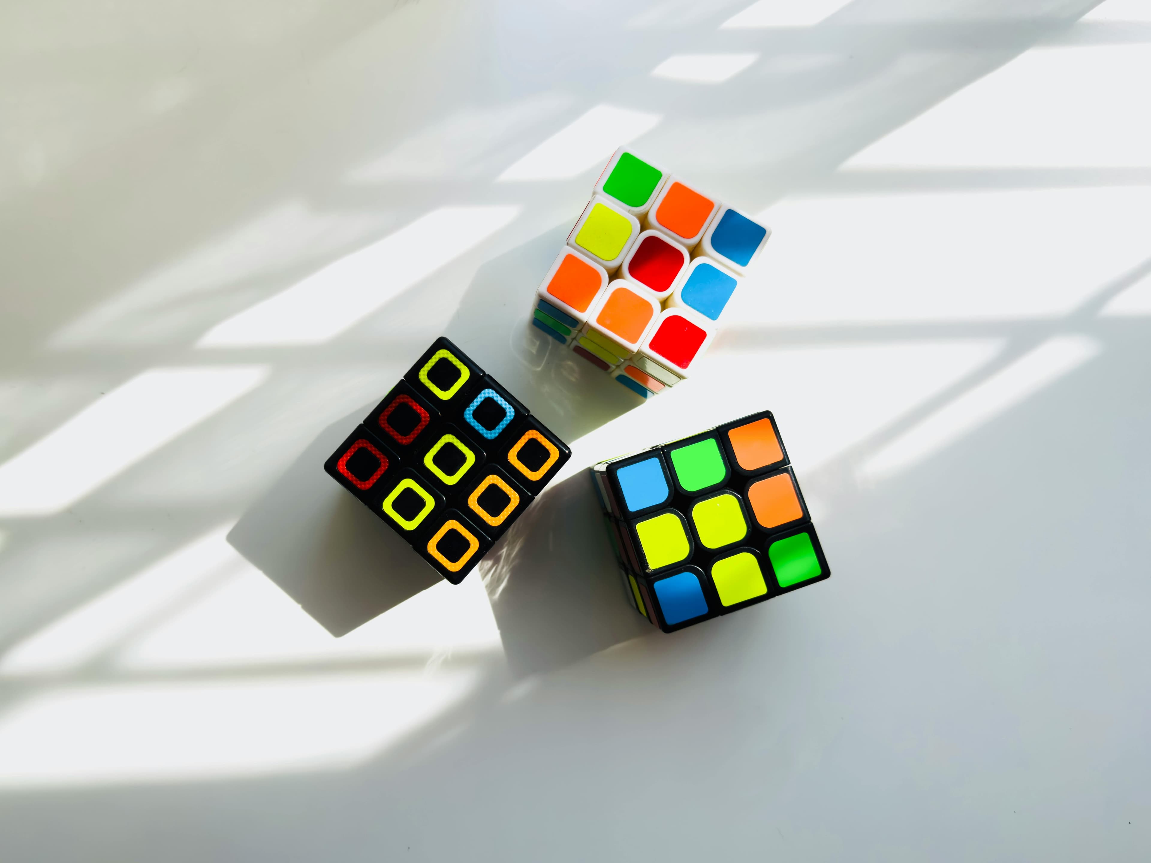 Three Rubik's Cube with three different colored palettes and all not solved